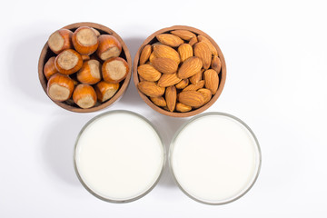 Glass of hazelnut milk and almond isolated on white background.