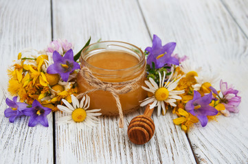 Jar of honey with wildflowers