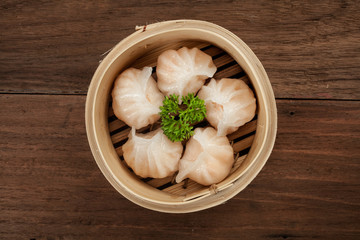 Chinese dumpling in a bamboo steamer box - obrazy, fototapety, plakaty