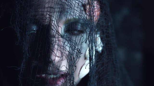 4k Halloween Shot of a Horror Woman Mermaid Grinning under Fishing Net