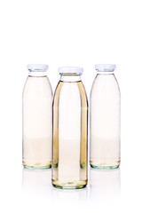 Translucent liquid in glass bottle on white background
