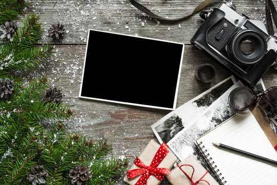 retro christmas background with vintage camera and blank photo