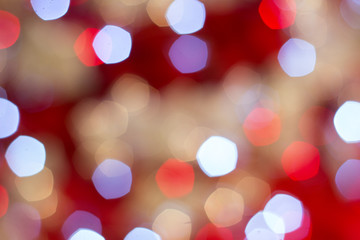Fototapeta premium Colorful lights on red background. holiday bokeh. Abstract Christmas background