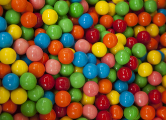 Close up of colorful candies texture background. Rainbow colorful candy coated chocolate pieces in a bowl (selective focus)