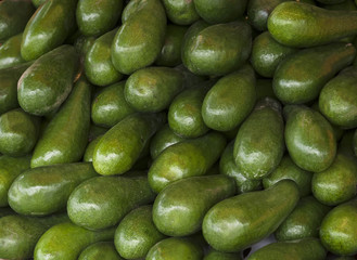 Avocado background. Fresh green avocado on a market. Food background.(selective focus)
