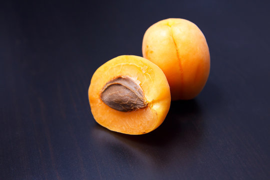 half of apricot on a black table