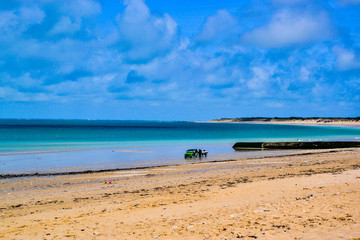 Old car bringing a boat at a beach in south France