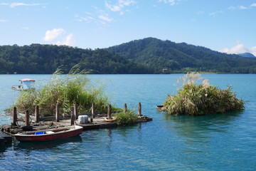 Naklejka na ściany i meble Boat on lake under blue sky at sun moon lake, Taiwan