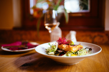 Restaurant food with fresh ingredients - grilled salmon and fresh salad