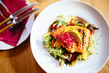 Restaurant food with fresh ingredients - grilled salmon and fresh salad