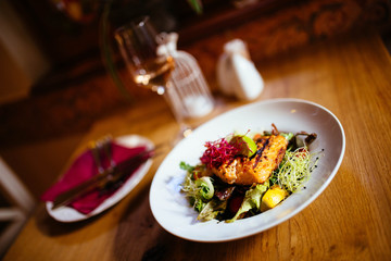 Restaurant food with fresh ingredients - grilled salmon and fresh salad