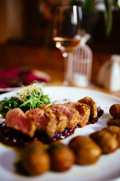 Restaurant food with fresh ingredients - pork tenderloin with grenaille potatoes and fresh salad