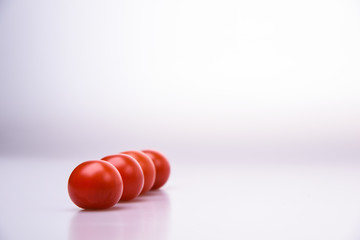 Fresh cherry tomatoes line isolated on white background cutout