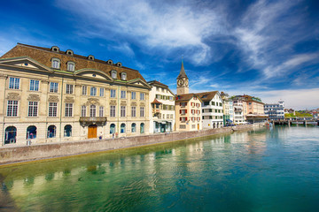 Fototapeta na wymiar Beautiful view of the historic city center of Zürich with famous Fraumünster Church and swans on river Limmat on a sunny day with blue sky, Canton of Zürich, Switzerland.