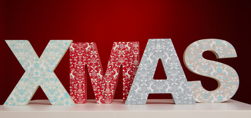 XMAS letters on a white wooden table