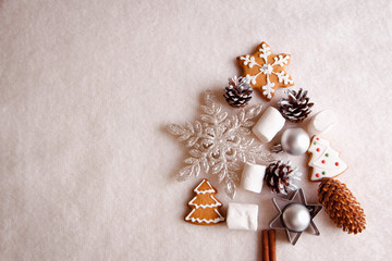 Beautiful Christmas tree made of gingerbread, marshmallows and Christmas decoration on light background