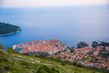 View from mountain at Old town of Dubrovnik in Croatia. Sunset in Adriatic sea.