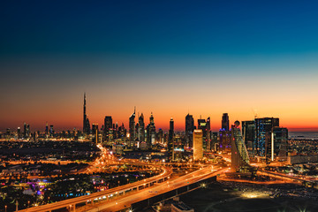 A beautiful Skyline view of Dubai, UAE as seen from Dubai Frame at sunset showing Burj Khalifa, Emirates Towers, Index Building, DIFC, World Trade Centre, H Hotel, Conrad and Etisalat Tower