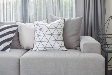 Light gray sofa with varies pattern pillows in modern living corner