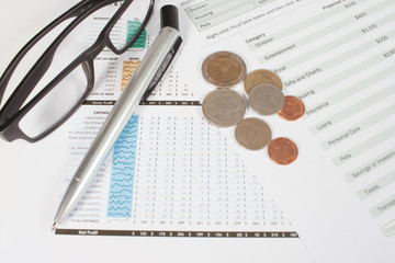 Business and financial report,Coins on the documen.