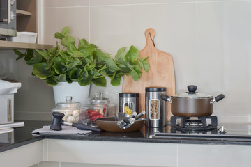 Fototapeta na wymiar Pot, pastas and seasoning jars on the counter in the kitchen