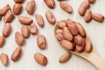 Peanuts on a wooden spoon.