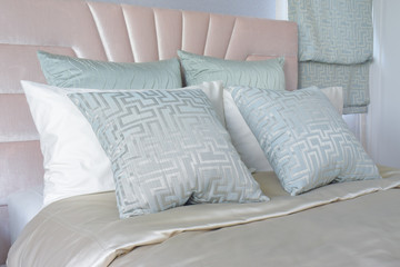 Satin finished pillows setting on bed