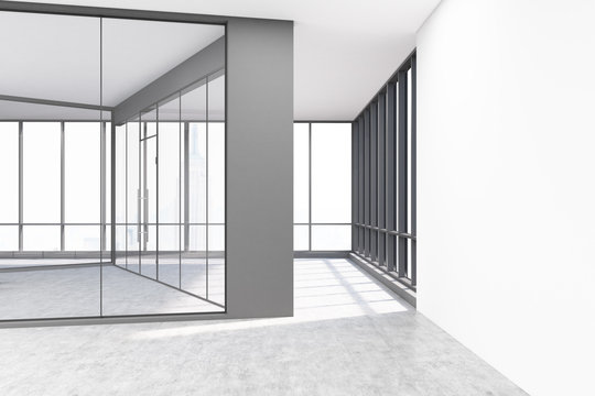 Empty office with glass and white concrete walls