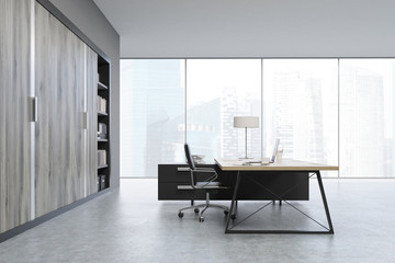 Side view of a CEO office with wooden doors and a bookcase