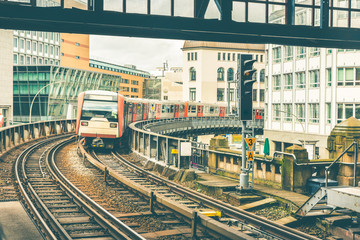 Fototapeta na wymiar Train on elevated tracks coming to the station in Hamburg