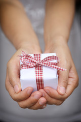 White Gift box on women hands.