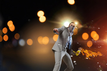 Businessman throwing petrol bomb . Mixed media