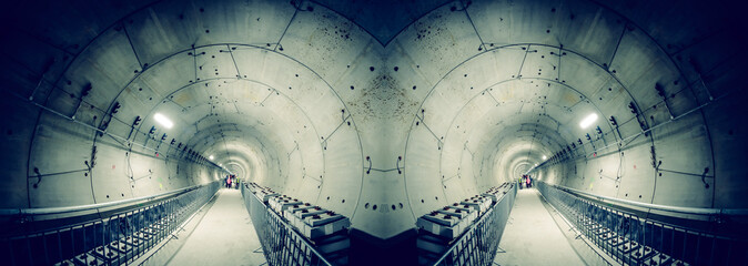 Underground tunnel with subway railway under construction, panoramic view with artistic HDR effect