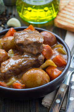 Hearty beef stew with carrot, celery, shallot and potato, vertical