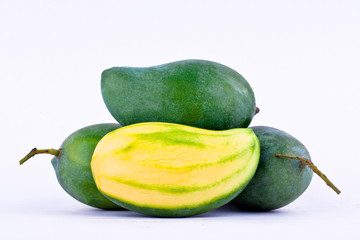 a pile fresh green mango and half mango on white background healthy fruit food isolated close up
