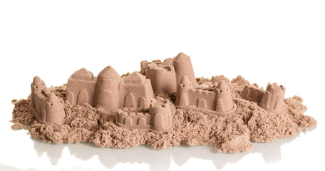 Battered sandcastles isolated on white