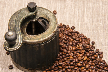 Hand old mill coffee beans on a gray background