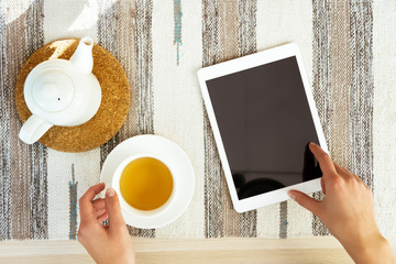 Set hands tablet computer tea cup table