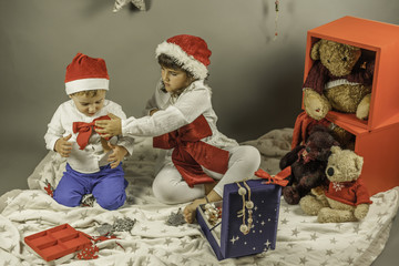Kids with Santa hat and red bow portrait shot in studio. Christm