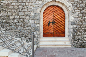 Old vintage wooden door in Budva citadel at old town