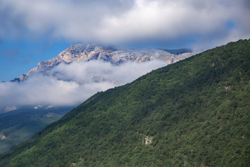 Fototapeta premium High mountains and clouds, beautiful nature landscape