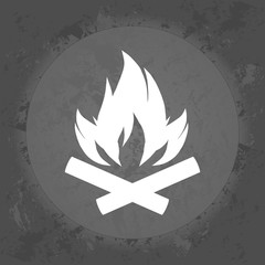 Fire flame icon on gray vintage background .