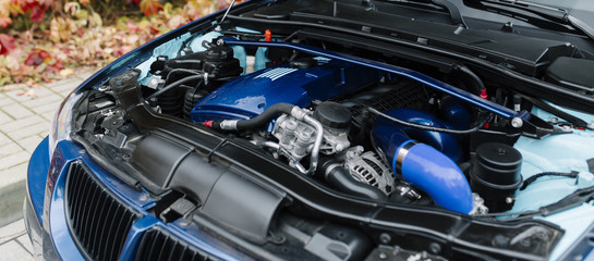 Engine motor of blue car under hood