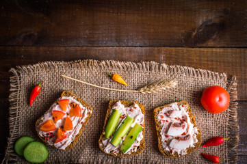 sandwiches on sacking on wooden background