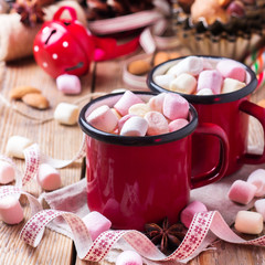 Hot chocolate with marshmallows and spices on christmas table