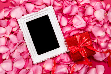 Empty photo frame with  sweet pink roses  petal and red gift box