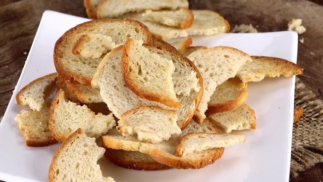 Portion of rotating Bread Chips as seamless loopable 4K UHD footage