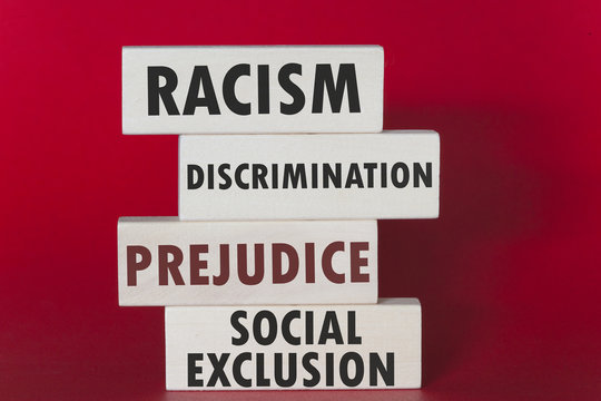 Racism, discrimination, prejudice and social exclusion message written on wooden tiles