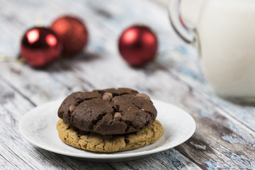Cookies and Milk for Santa / Cookies and milk with Christmas decoration on a wooden background
