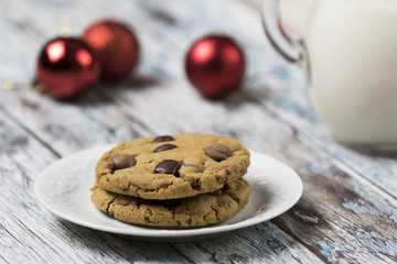 Cookies and Milk for Santa / Cookies and milk with Christmas decoration on a wooden background